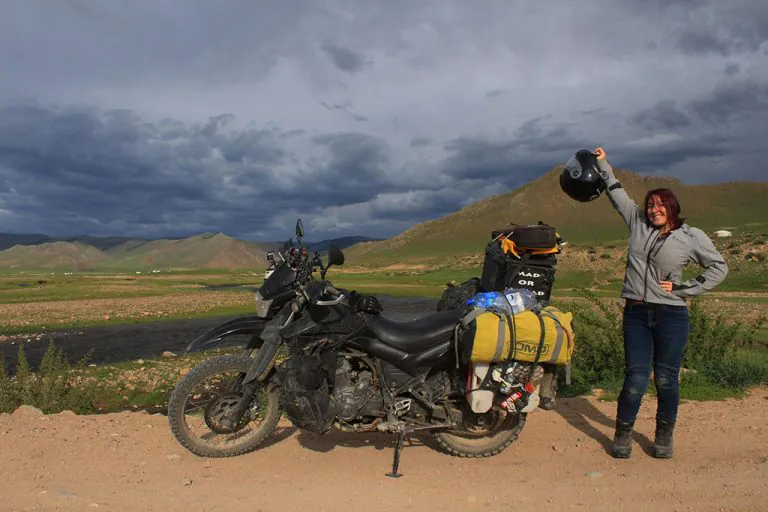 Girl adventuring biking in Mongolia