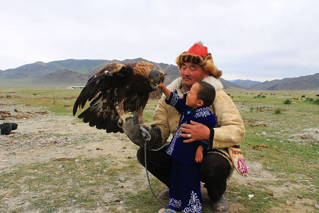 Eagle hunter family in Mongolia with his grandson